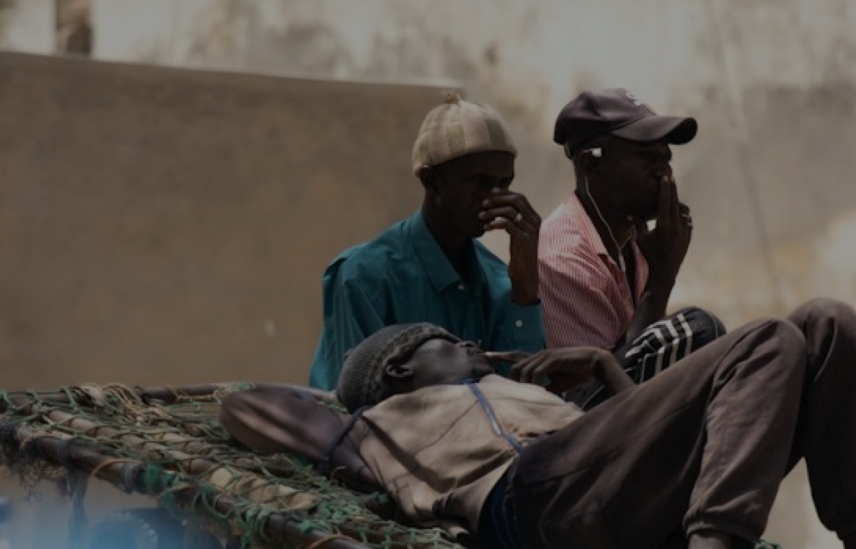 Young men resting together in a courtyard
